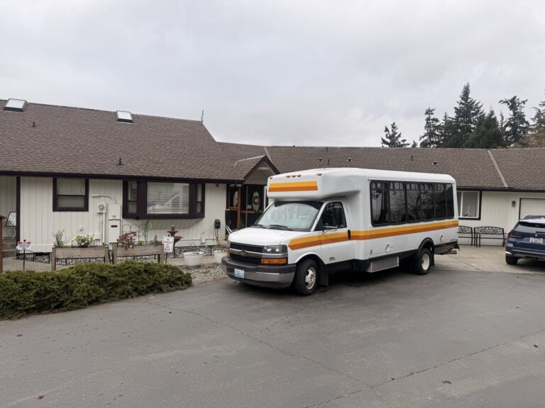 Tacoma adult family home exterior with resident transport van parked in the driveway