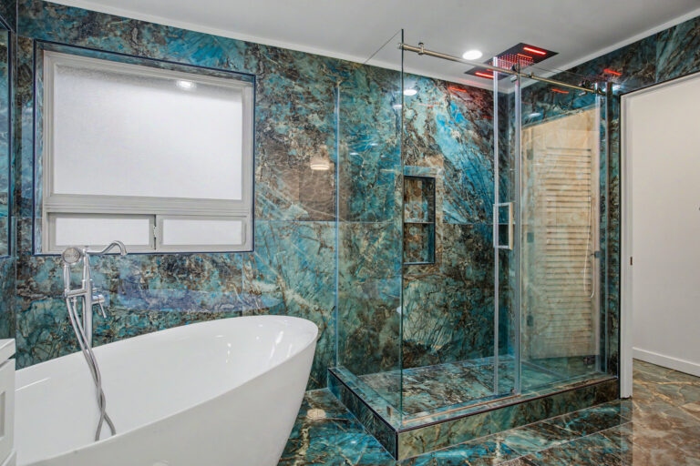 Blue quartzite bathroom walk-in shower enclosure alongside a freestanding soaking tub